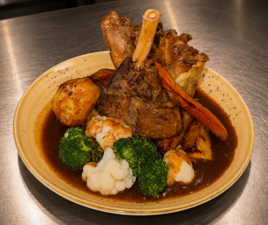 Slow-roasted lamb shank with roast potatoes, broccoli and rich gravy
