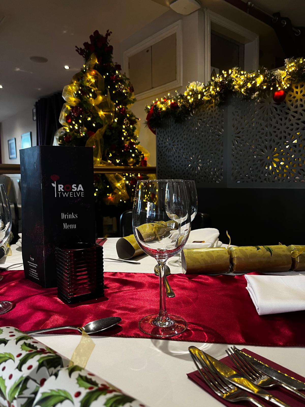 A festive table setting with crackers at Rosa Twelve